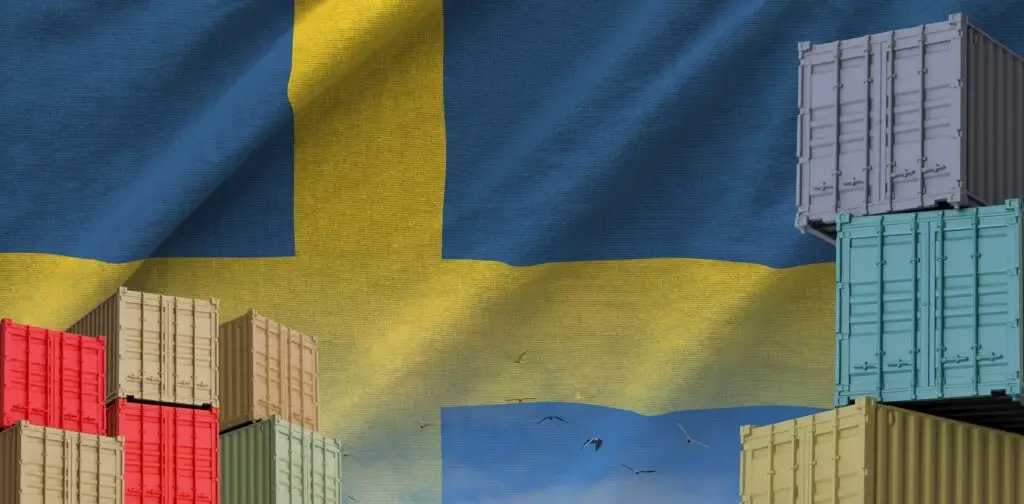sweden,flag,and,big,stack,of,shipping,cargo,containers,in